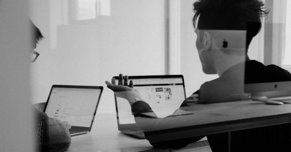 Black and white two men with laptops