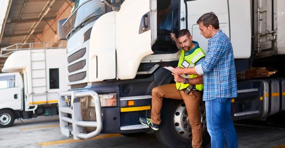 Delivery truck driver looking at papers
