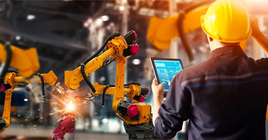 Worker with hard hat and manufacturing machine