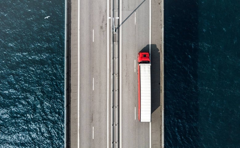Red truck driving on road