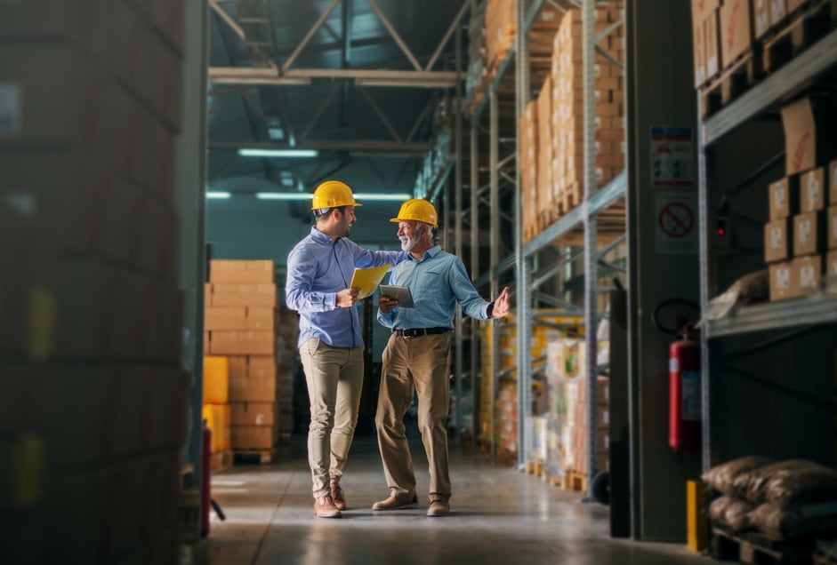 Two men walking through the warehouse