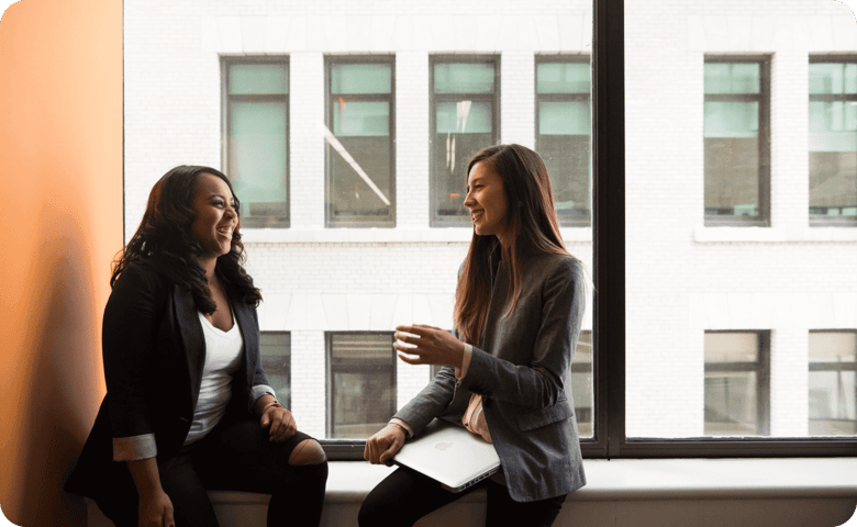 Two woman sitting at a window