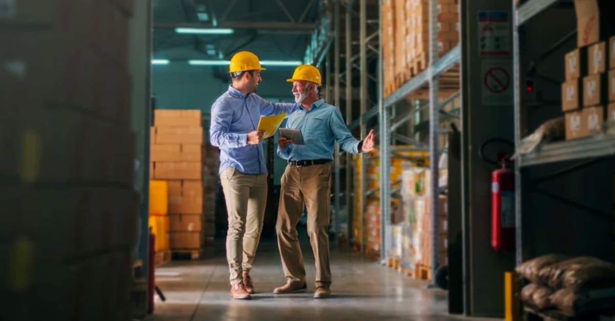 Two men walking through the warehouse