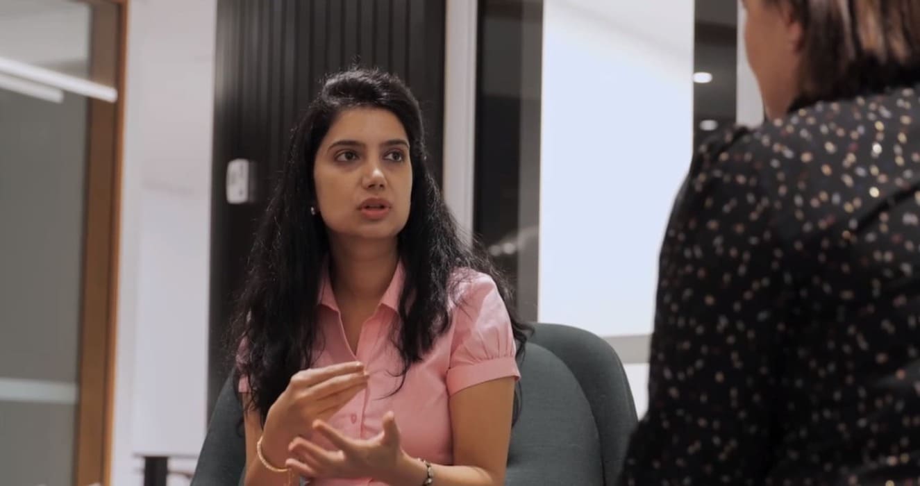 NAATI Ashwini Shankar talking to a coworker