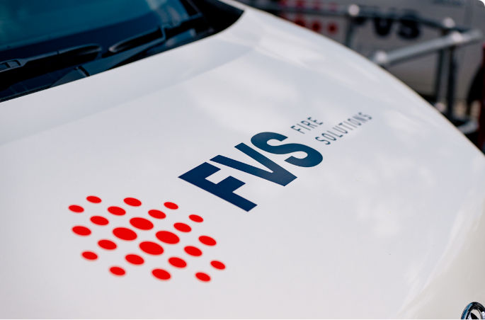 Logo of FVS Fire Solutions on a white car
