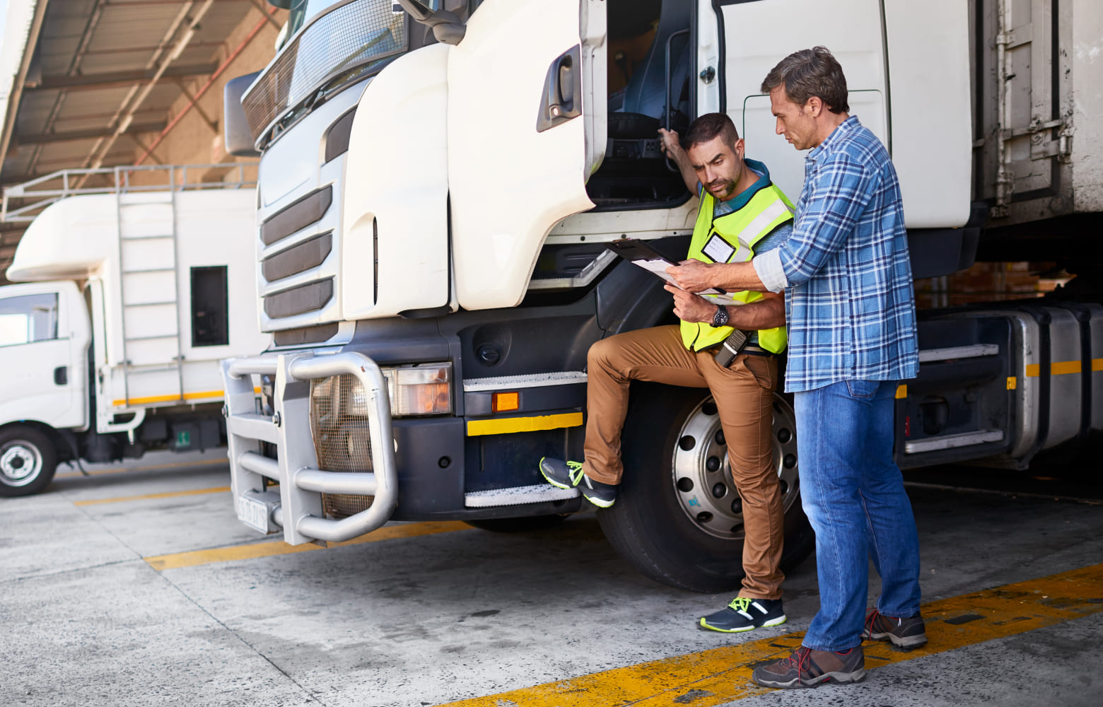 Delivery truck driver looking at papers