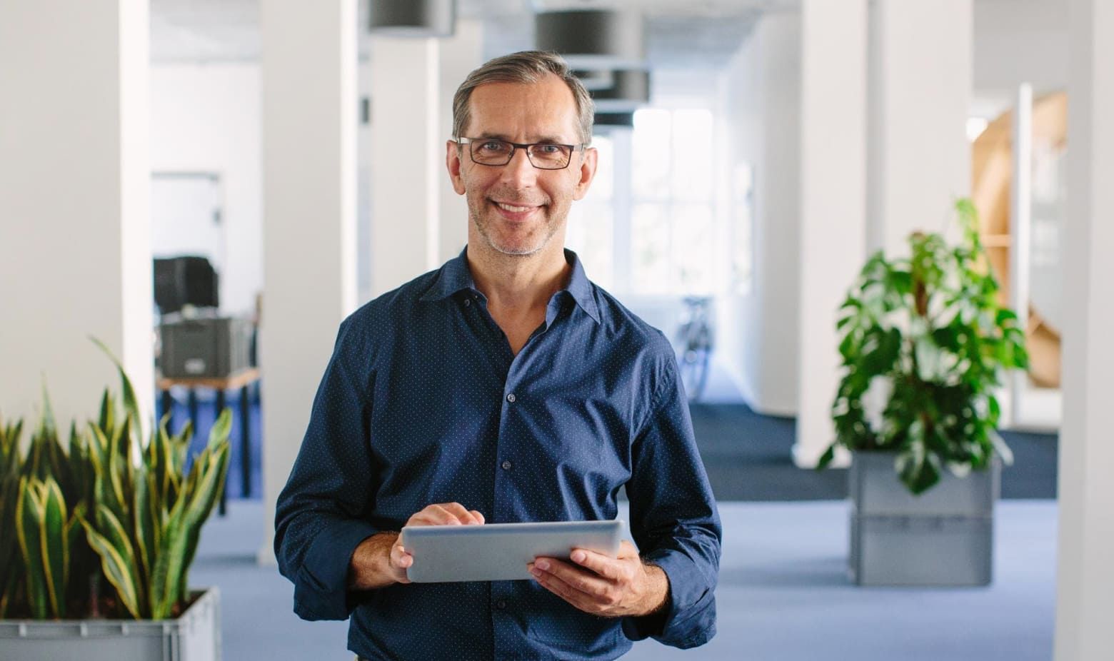 Man holding tablet and smiling