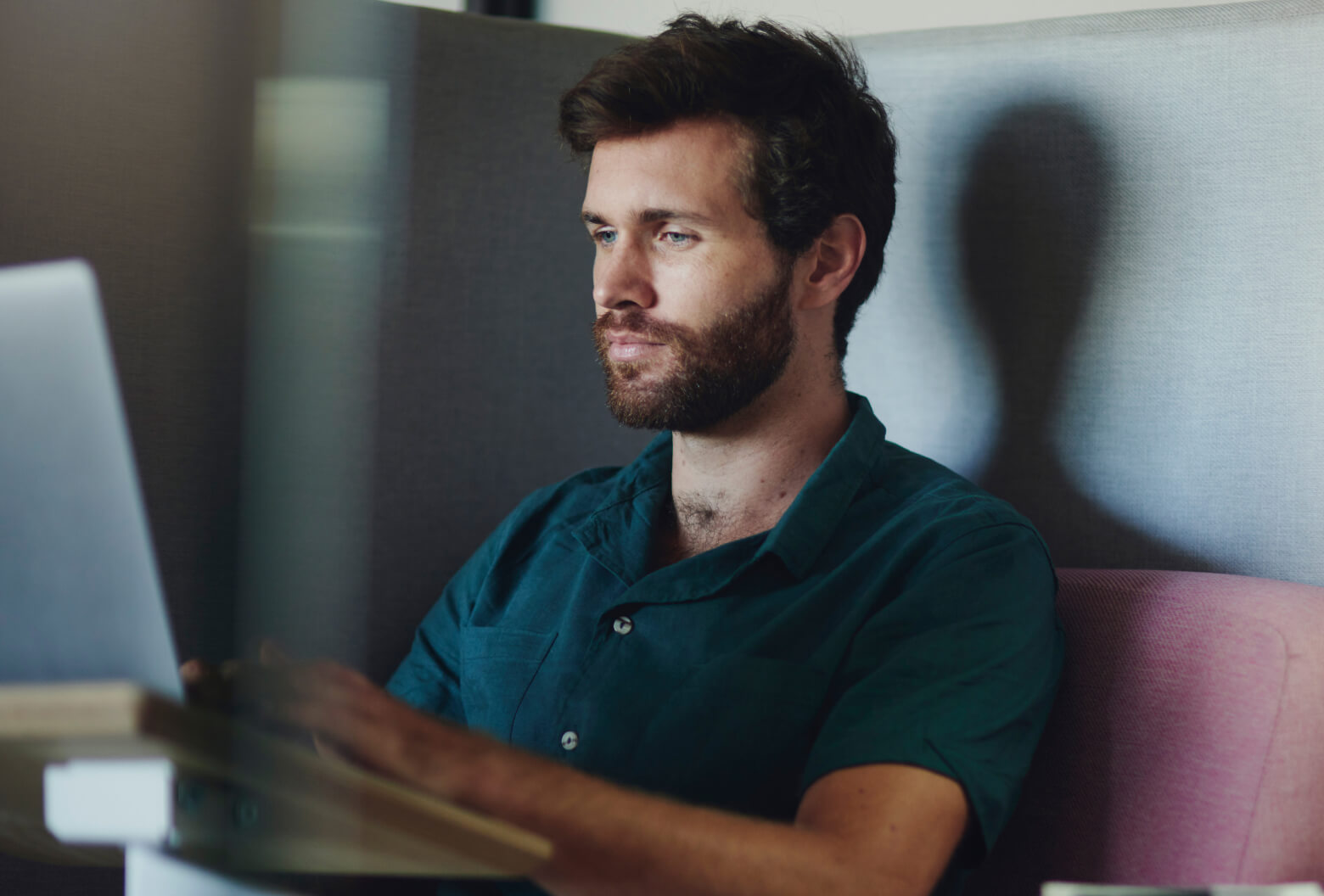 Man sitting and looking at laptop