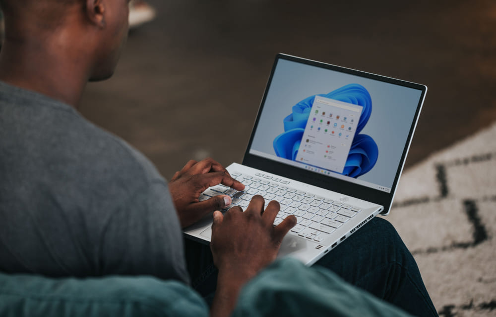 Man on laptop with Microsoft Windows displayed