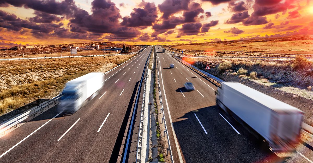 Trucks driving left and right with sunset backdrop