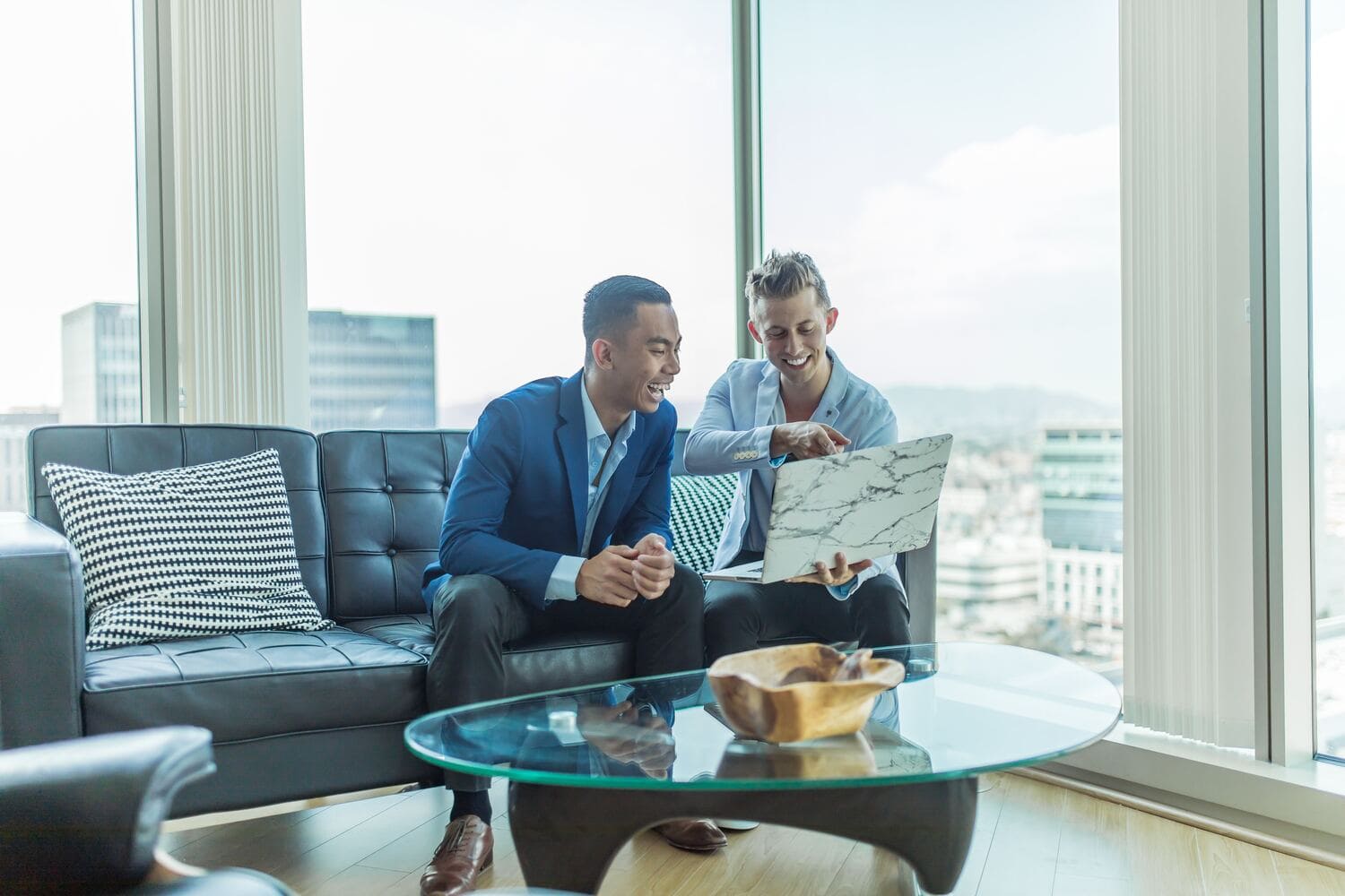 Two men in a sitting in an office sofa