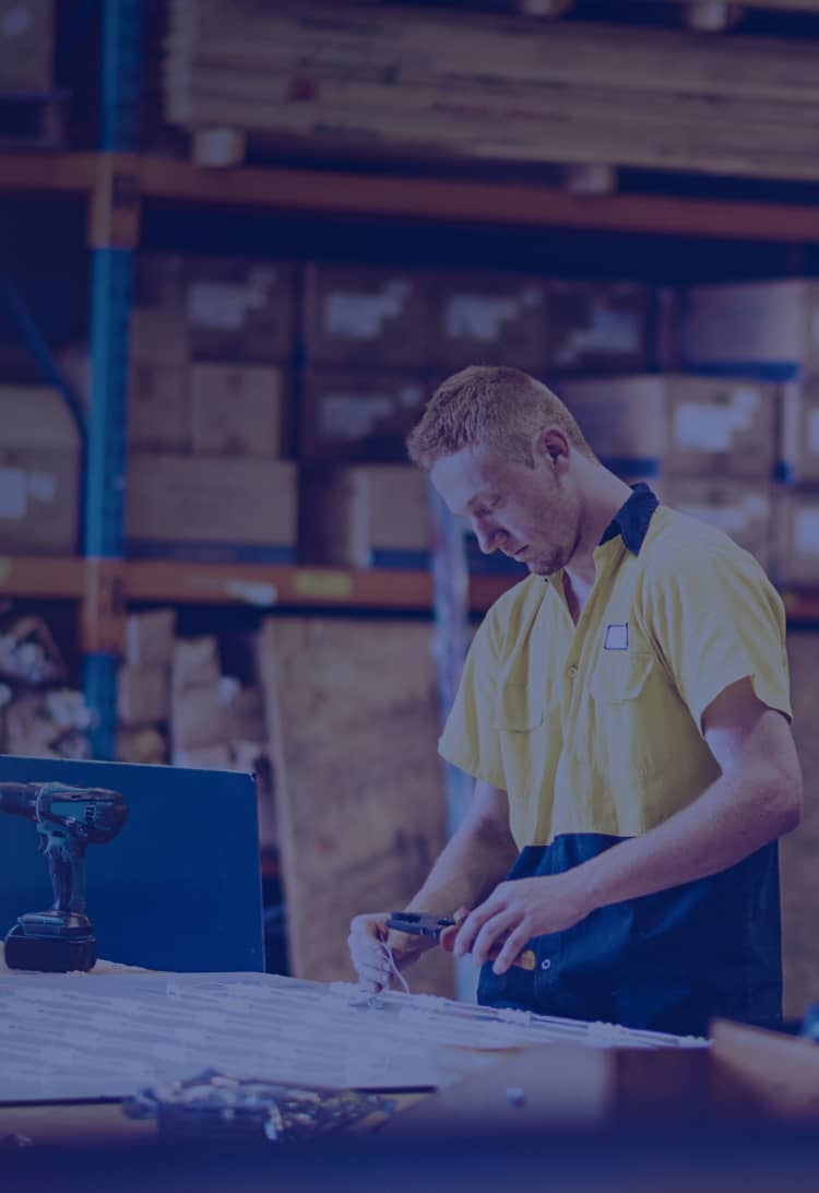 Warehouse worker with tools on desk