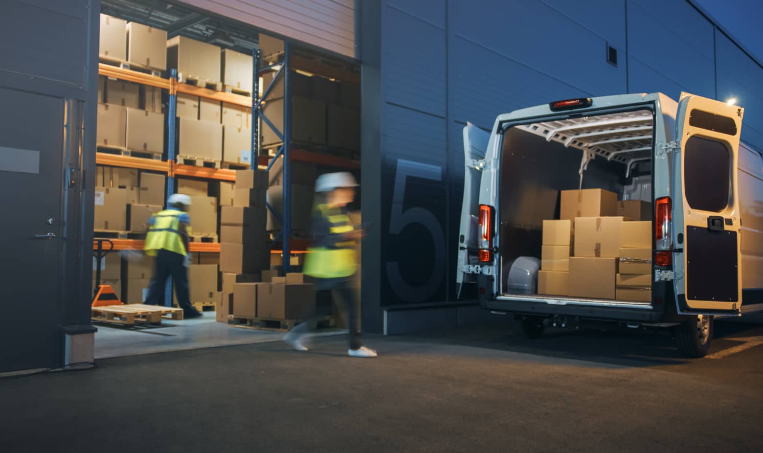 Warehouse workers offloading a delivery truck