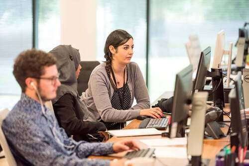 Workers looking at their computer screen